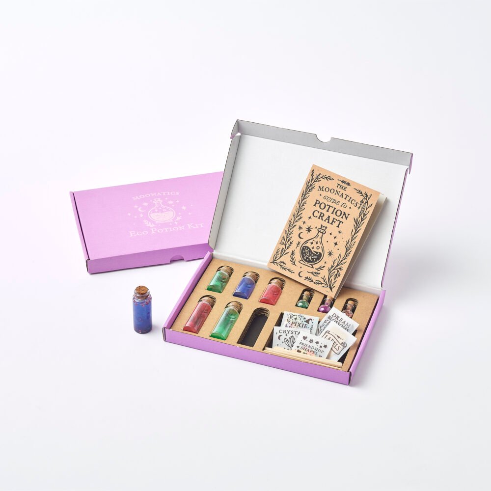 Apprentice Eco Potion Kit contents — potion bottles filled with mica powder, biodegradable glitter, and natural magical mix-ins.