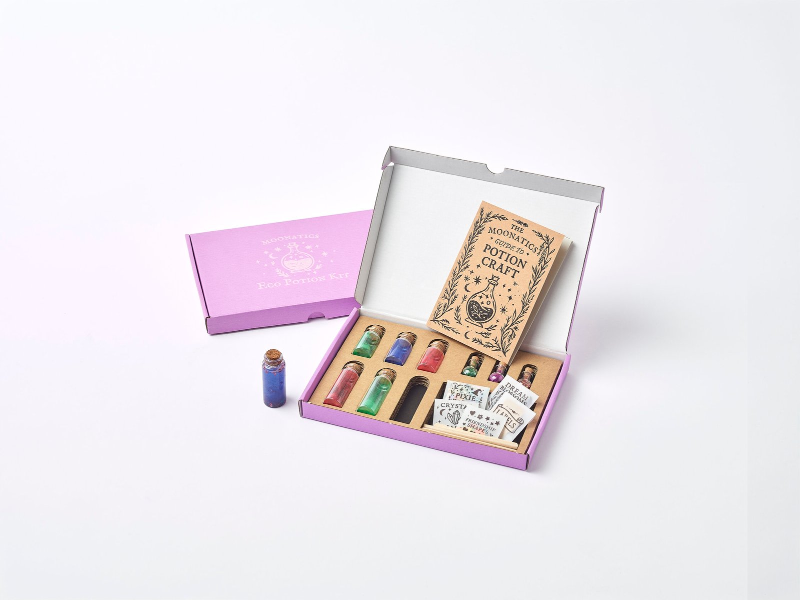 Apprentice Eco Potion Kit contents — potion bottles filled with mica powder, biodegradable glitter, and natural magical mix-ins.