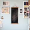 lunar-calendar-2027-artist-studio-wall Moonatics 2027 lunar calendar displayed on a pale green artist studio wall