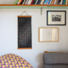 lunar-calendar-2027-colourful-home-interior Moonatics 2027 lunar calendar hanging beneath bookshelves beside framed artwork and colourful fabric