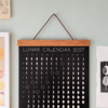 lunar-calendar-2027-title-and-hanger-detail Detail of the Lunar Calendar 2027 title, teak hanger and hanging cord