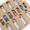 moonatics alchemist eco potion kit - bottles and glitter close up at angle Close-up of glass potion bottles, eco glitter and coloured mica powders arranged in a kraft card tray.