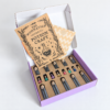 moonatics alchemist eco potion kit - open box Open purple Alchemist Eco Potion Kit showing the craft guide and glass potion bottles in a kraft card tray.